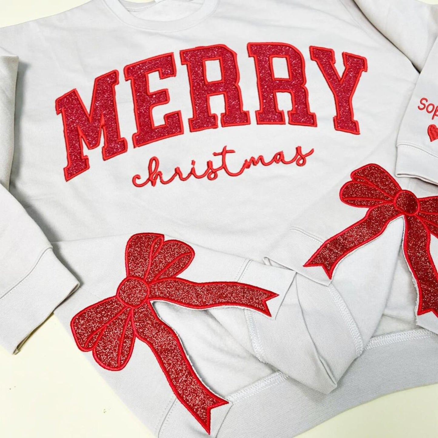 Merry Side Bow Cut-Out Sweatshirt With Glitter